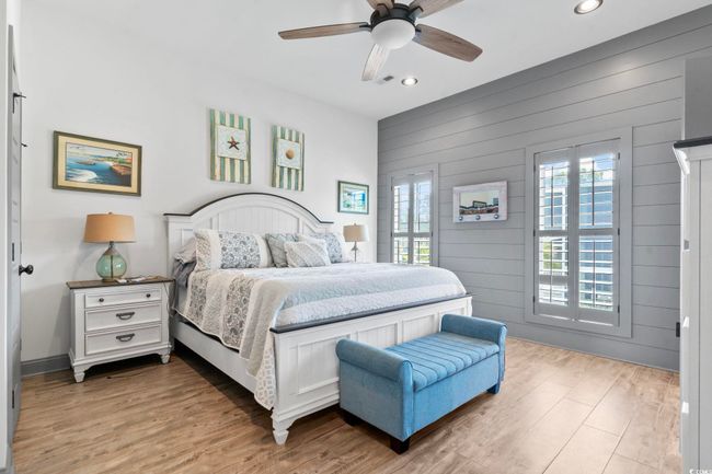 Bedroom with light wood finished floors and recessed lighting | Image 15