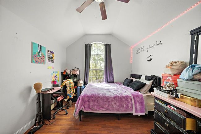 A standout among the secondary bedrooms, this room impresses with its high ceilings, rich flooring, and striking architectural window. The generous square footage provides ample room for a larger bed, workspace, and extra storage, making it ideal for long-term comfort. | Image 24