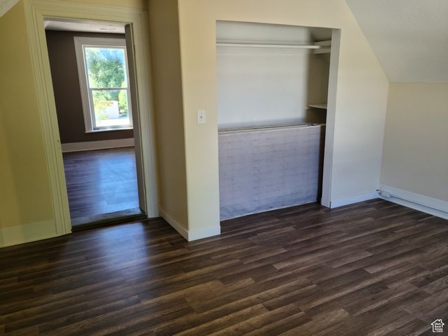 Unfurnished bedroom featuring dark wood finished floors, baseboards, and a closet | Image 28