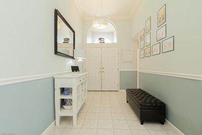 Foyer featuring light tile patterned flooring and crown molding | Image 3