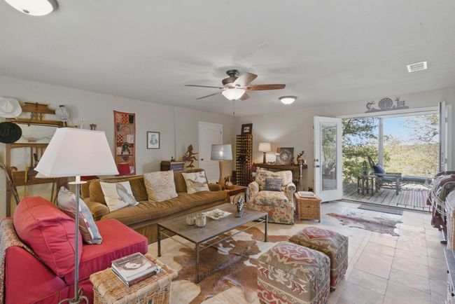 The large downstairs den leads to a covered porch with lake views. | Image 21