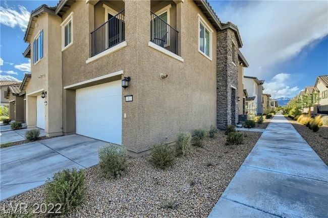 View of home's exterior featuring stucco siding, driveway, a residential view, and an attached garage | Image 23