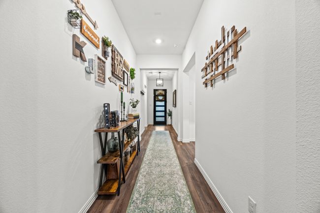 Doorway featuring dark wood-style floors and baseboards | Image 10