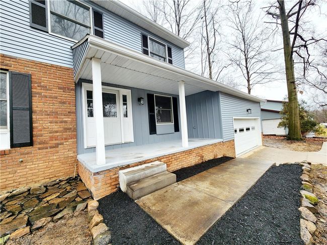 View of exterior entry with a garage and a porch | Image 25