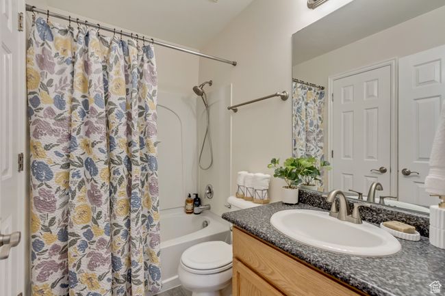 Bathroom featuring shower / bath combo, toilet, and vanity | Image 14