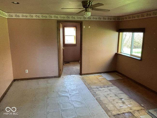 spare room featuring baseboards, light floors, and ceiling fan | Image 11
