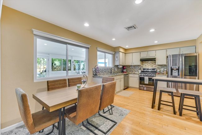 Tucked just off the kitchen, the dining area is perfectly placed for casual weeknight meals or cozy dinners with friends, with a clear view into both the living room and sunroom | Image 8