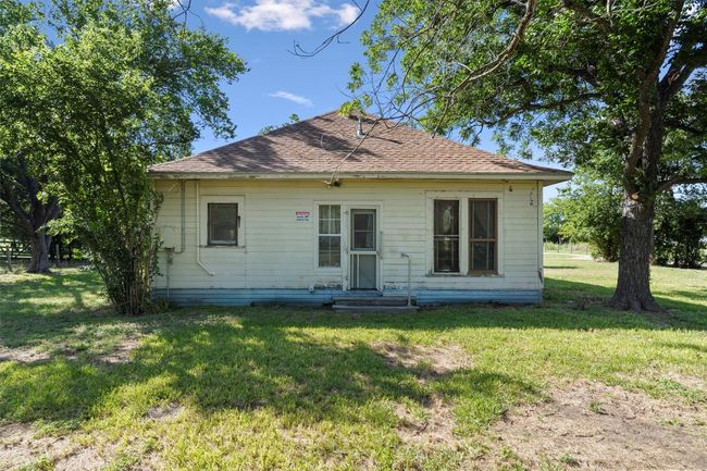 Rear view of property featuring a shingled roof and a lawn | Image 24
