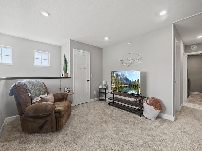 Upper level versatile 15 x 13 den, ideal for a home office or additional living space. Multiple windows bring in natural light, while a closet offers extra storage. | Image 25