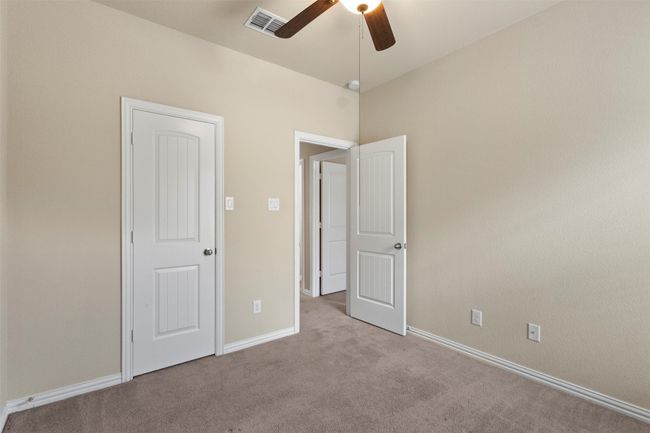 Unfurnished bedroom with carpet flooring and ceiling fan | Image 16