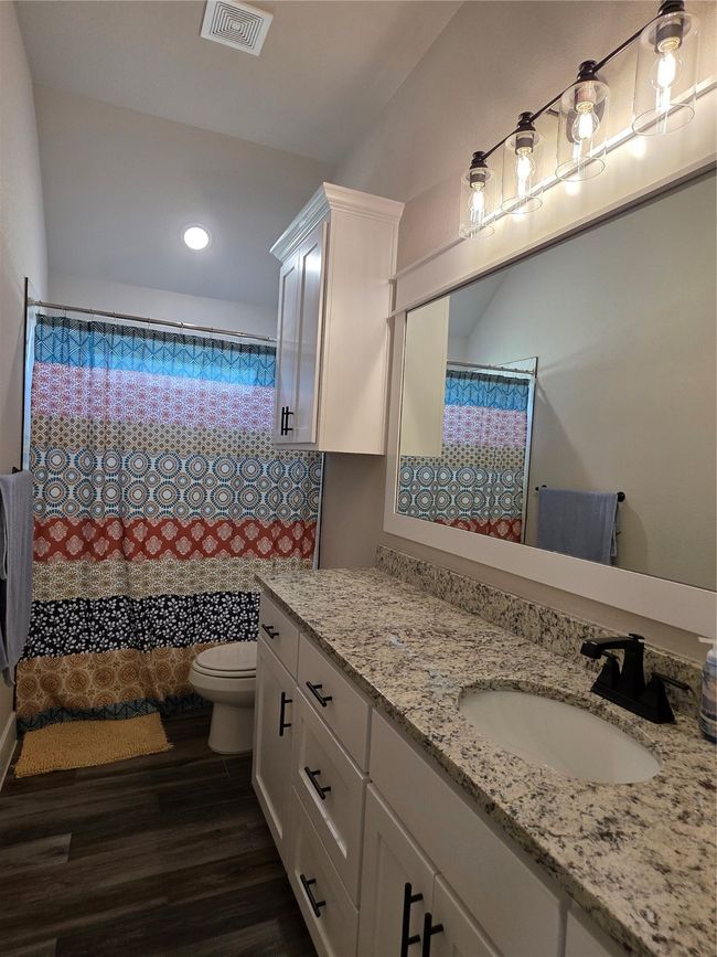 Full bathroom featuring vanity, wood finished floors, recessed lighting, and a shower with shower curtain | Image 32