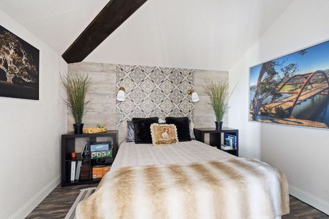 Bedroom featuring dark wood-type flooring, vaulted ceiling | Image 31