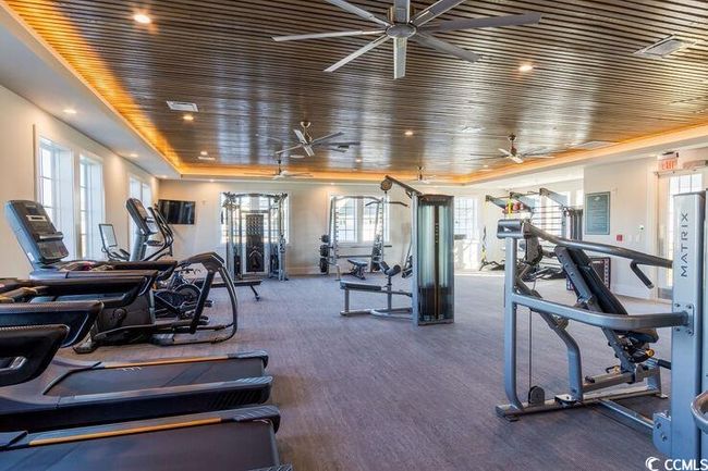 Exercise room with wooden ceiling, recessed lighting, a ceiling fan, and visible vents | Image 19