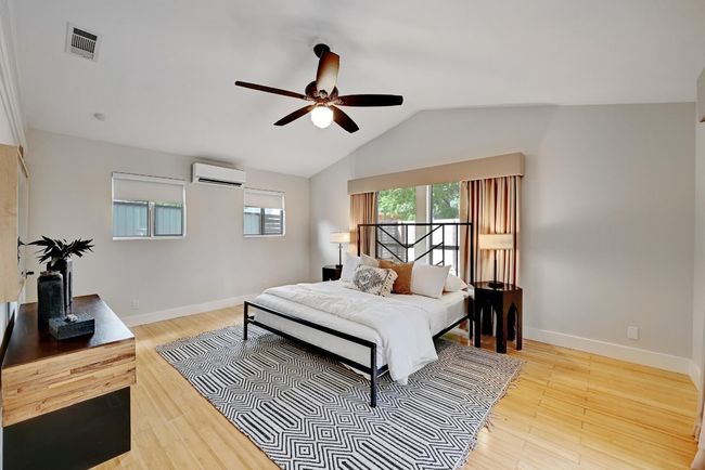 Bedroom with wood floors, vaulted ceiling | Image 17