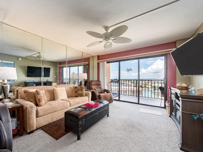 Living room opens to a large balcony | Image 12