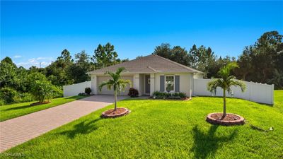 Single story home with a garage and a front lawn | Image 2