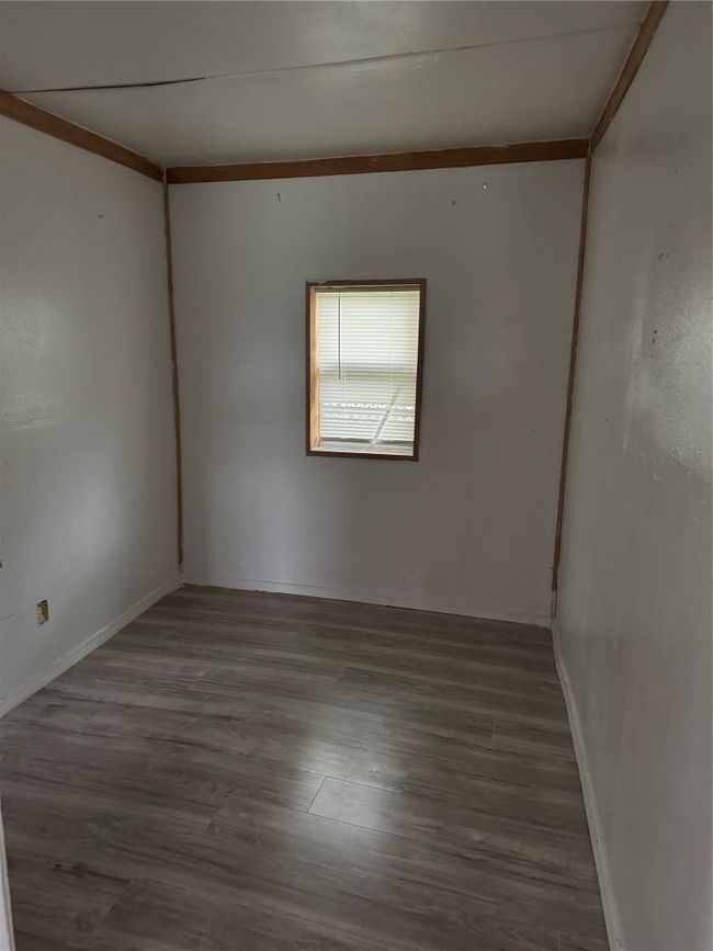 Unfurnished room with wood finished floors and baseboards | Image 4