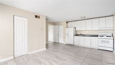 opens up to Living room with pantry and coat closet to the left | Image 3