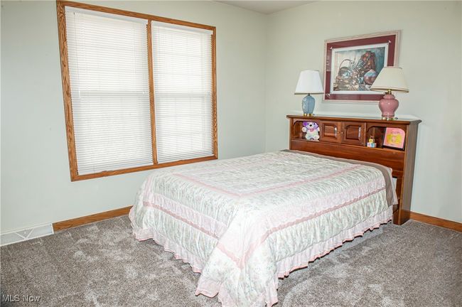 Bedroom featuring baseboards, carpet floors, and visible vents | Image 16