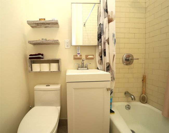 Full bathroom with toilet, shower / tub combo with curtain, and vanity | Image 13