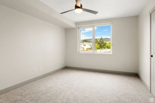 Carpeted empty room with ceiling fan and baseboards | Image 19
