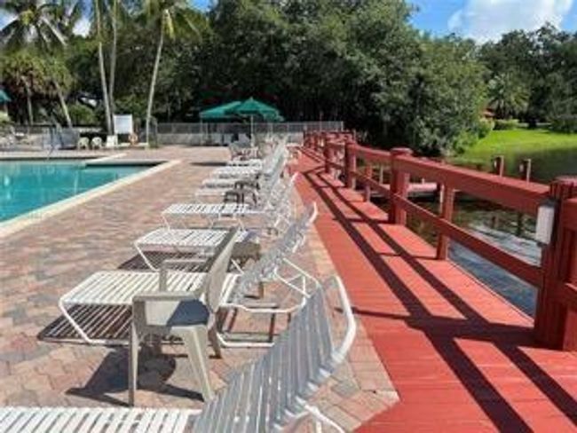 Clubhose Pool Area Deck Overlooking Lake And Water Fountain | Image 33