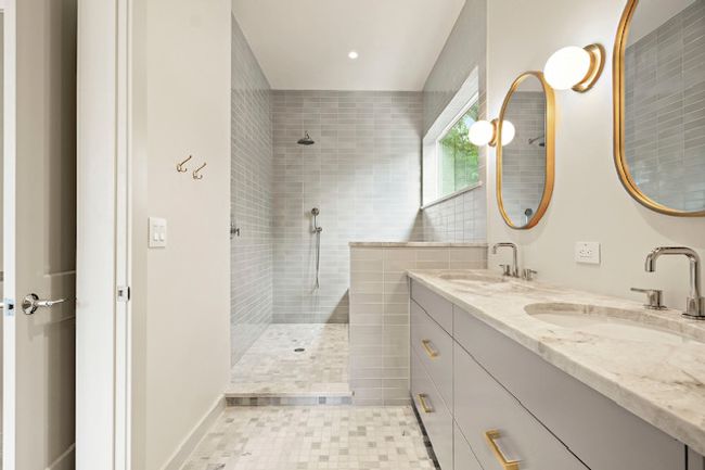 Bathroom featuring a walk in shower, double vanity, and tile patterned flooring | Image 14
