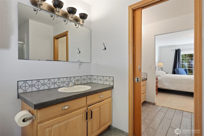 Dual vanities split by a pocket door. | Image 29