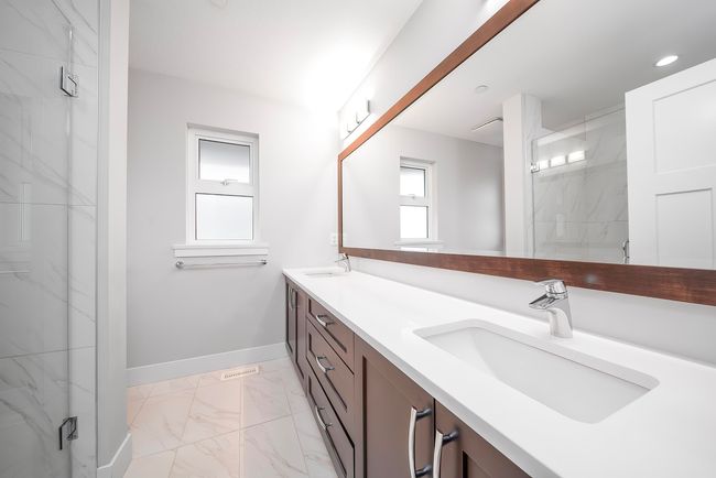 Full bath with marble finish floors, double vanity, a marble finish shower, baseboards, and recessed lighting | Image 19