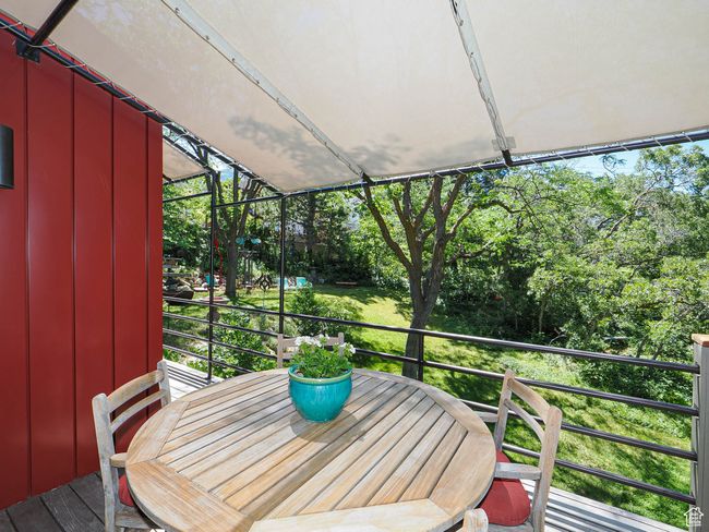 Balcony with view of wooded area and outdoor dining area | Image 70