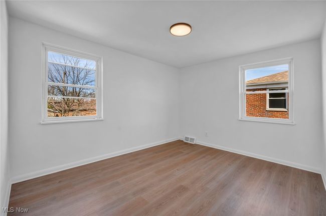 Empty room featuring visible vents, baseboards, and light wood-type flooring | Image 21