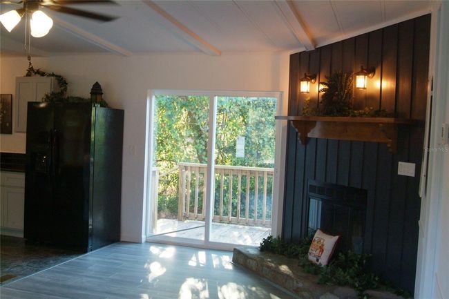 View out sliding glass door to rear deck and backyard | Image 14