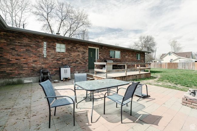 View of patio with fence and outdoor dining area | Image 33