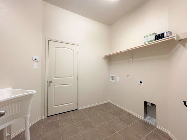 Laundry area featuring hookup for a washing machine, tile patterned floors, hookup for an electric dryer, and gas dryer hookup | Image 17