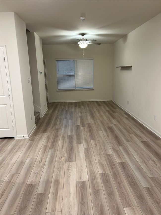 Spare room featuring baseboards, wood finished floors, and ceiling fan | Image 4