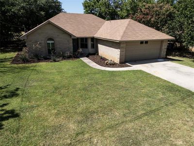 Single story home featuring a garage and a front lawn | Image 1