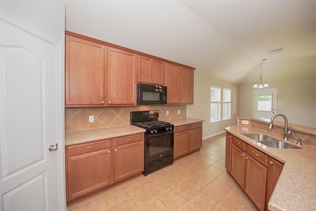 Kitchen also provides great storage with large cabinets. | Image 11