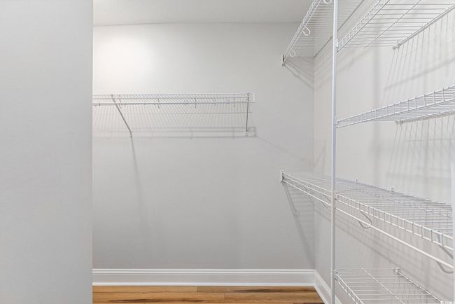 Walk in closet featuring wood finished floors | Image 20