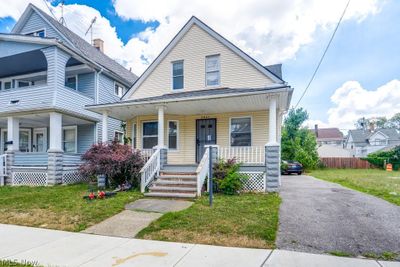 Bungalow-style home with a porch and a front lawn | Image 1