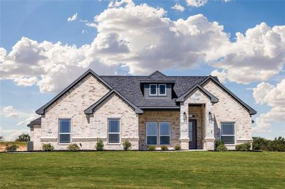 View of front of home featuring a front lawn and central AC | Image 1