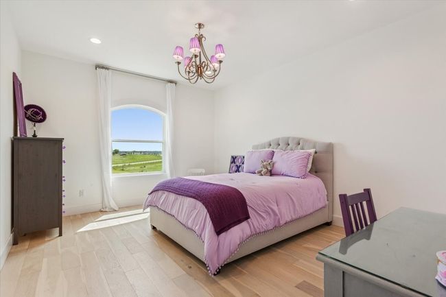 Bedroom with a chandelier, light wood-style flooring, recessed lighting, and baseboards | Image 30