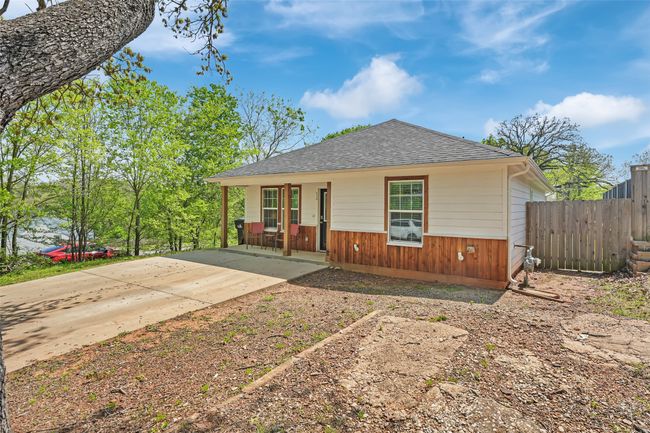 Bungalow-style house featuring roof with shingles, covered porch, fence, and driveway | Image 4