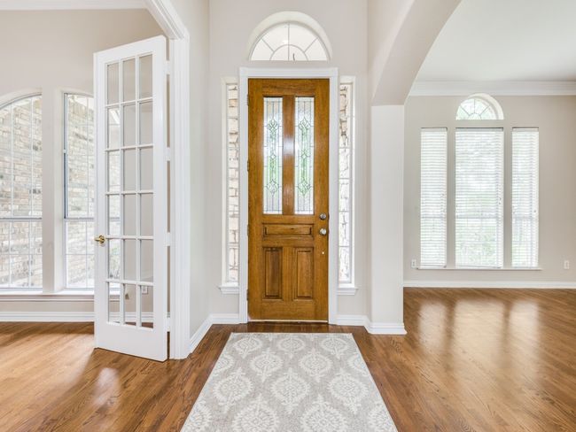 Entryway with wood finished floors and crown molding | Image 4