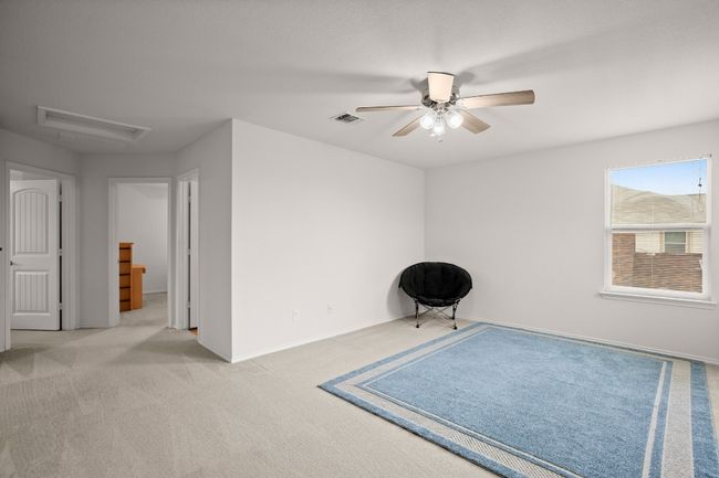 Unfurnished room with a ceiling fan and carpet floors | Image 11