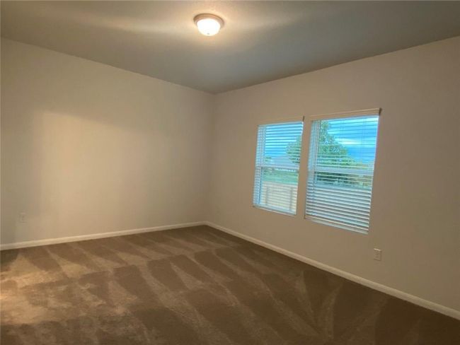 Spare room with baseboards and dark colored carpet | Image 5