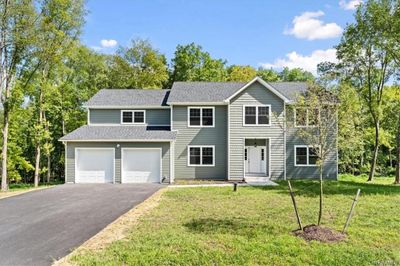 View of front of house with a front lawn and a garage | Image 2