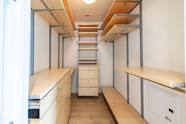 Spacious walk-in primary closet with ample storage. | Image 12