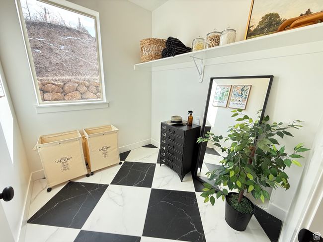 Laundry area featuring marble finish floor and baseboards | Image 11