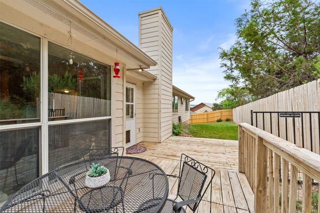 Wooden terrace featuring a fenced backyard and outdoor dining space | Image 35