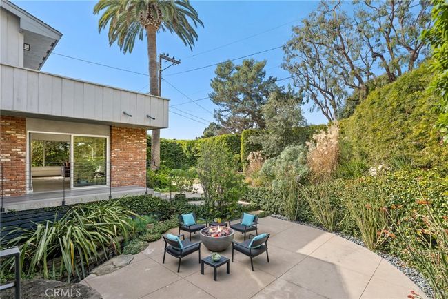 Private grounds beckon with a BBQ patio off the kitchen, a lush lawn and manicured gardens | Image 25